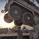 Illustration for article titled It Takes Three Extreme Machines To Flatbed An MRAP With A Blown Tire